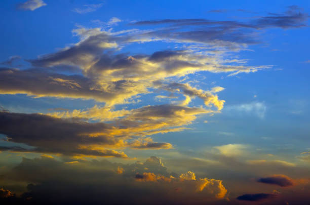 view of cloudy sky over hills at dusk