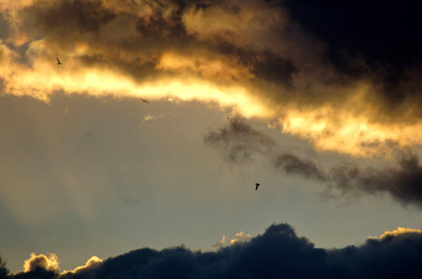 view of cloudy sky over hills at dusk