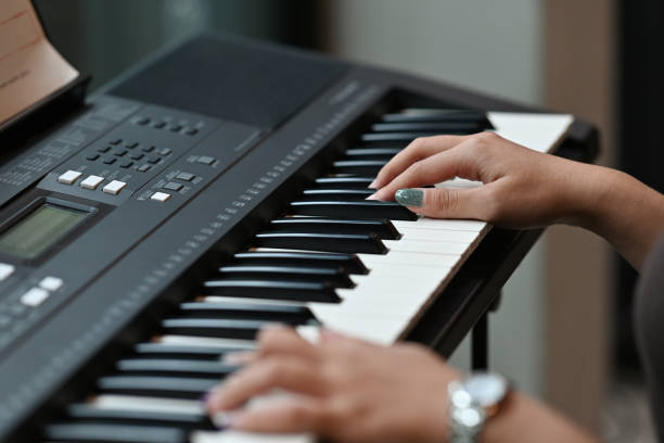 istock Close up with Asian musician woman's hand playing electone. 2104522541