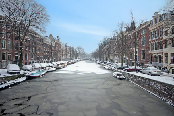 Bicycles in Amsterdam street near water canal in Autumn day