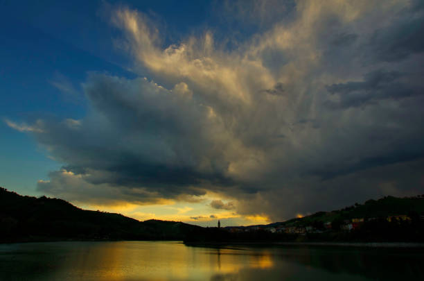 view of cloudy sky over Mercatale lake at dusk