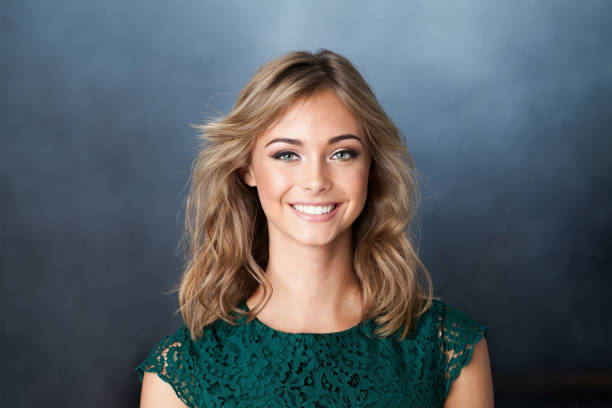 istock Nice young friendly woman smiling on blue background 2104536609