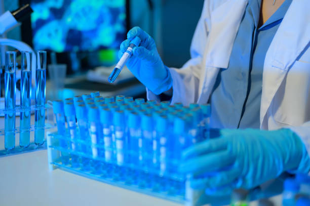 istock A scientist is holding a blue pipette and working with a blue liquid 2104539352