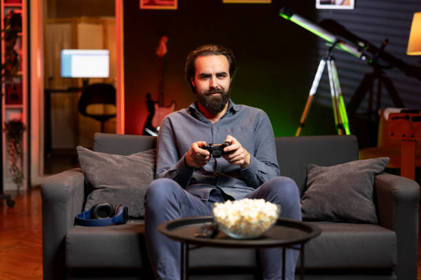 istock Portrait of man playing boring videogame on gaming console 2104545187