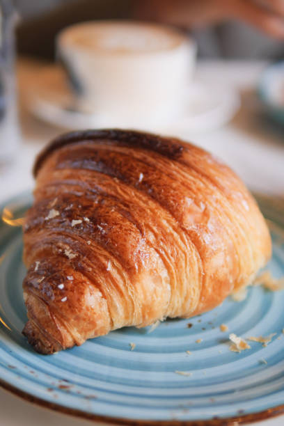 istock fresh baked croissant on plate with copy space 2104551967