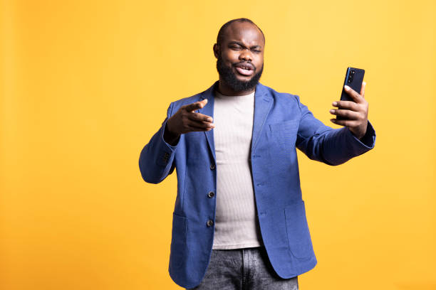 istock Person has fun with mates during online video call on phone, studio background 2104568323