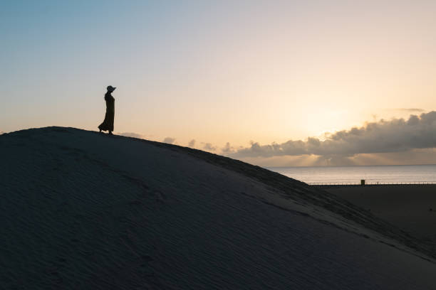 istock Silhouette of a woman with her hat 2104577358