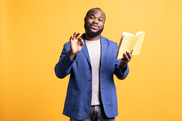 istock Joyous person showing positive hand gesturing, enjoying novel, studio background 2104581704