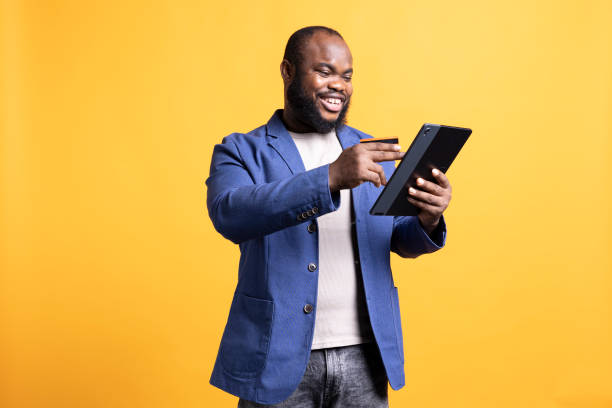 istock Happy man excited to do internet shopping, isolated over studio background 2104583289