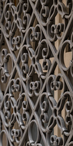 istock Forged metal protective grille on an old window. Metal pattern. building for safety. 2104586530