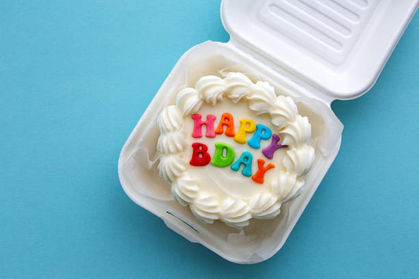 Mini birthday cake with colorful happy birthday message in a cardboard lunch box