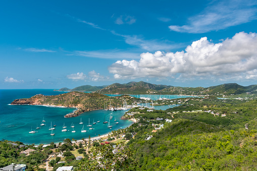 View point from above looking over the coastline of Antigua with sail boats in the bay and tropical beaches