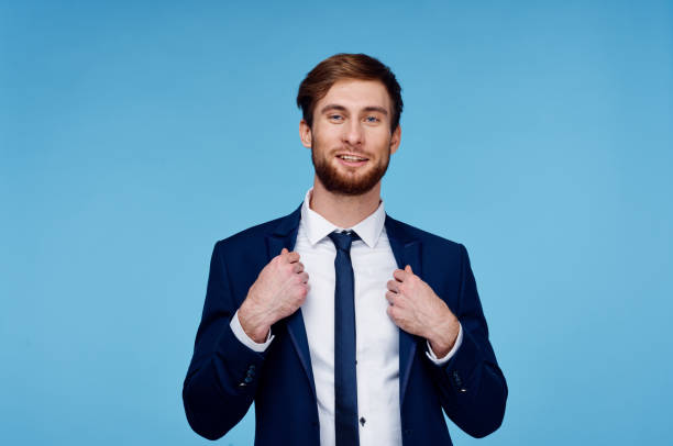 istock handsome man in suit self-confidence official blue background 2104604259
