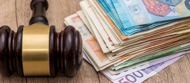 istock financial judgment with wooden judge's hammer and stack of eu euro banknotes 2104610114