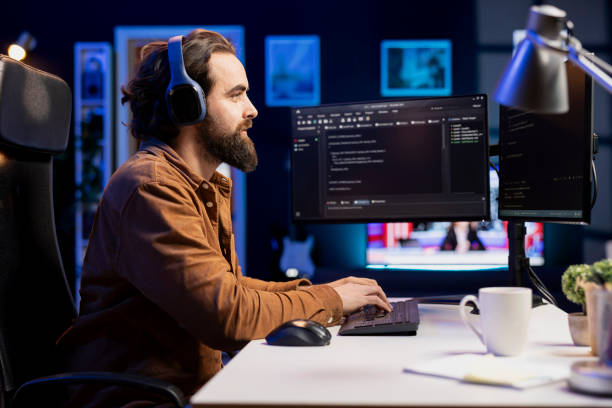 istock Programmer at home enjoying podcasts and building firewalls protecting data 2104613793