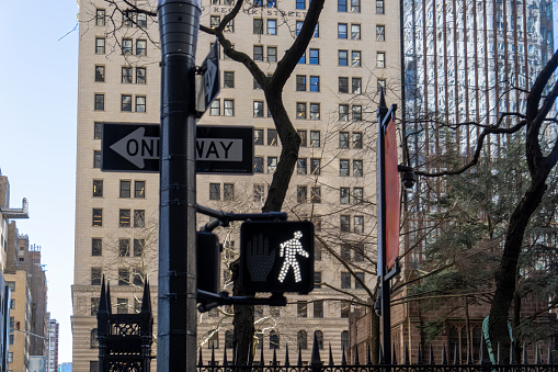 Cross walk sign near Trinity Church cemetery in the heart of the Wall Street Financial district of Manhattan.