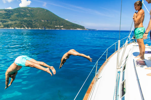 istock Group of young people spending time together on sailing vacation 2104621160