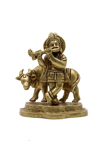 vintage lord krishna statue playing flute music beside a cow, a vishnu avatar isolated in a white background