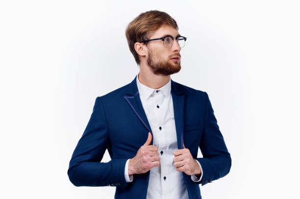 istock blond man in classic suit straightens jacket sleeve cropped view 2104628998