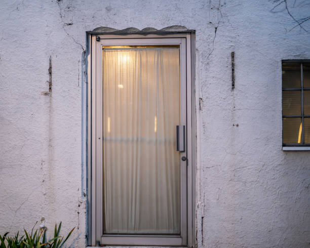istock Old Door White Wall Outside Stylistic 2104629544