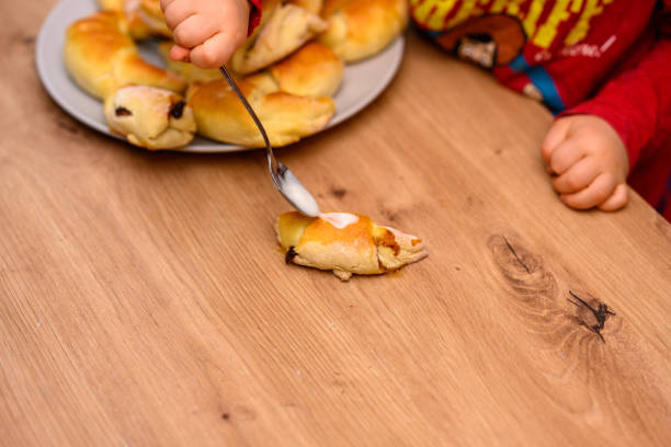 istock Decorating croissants with child 2104629569