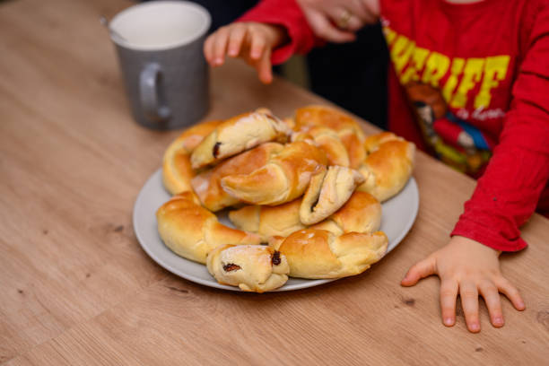 istock Decorating croissants with child 2104630633