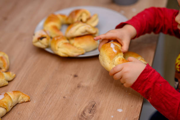 Decorating croissants with child