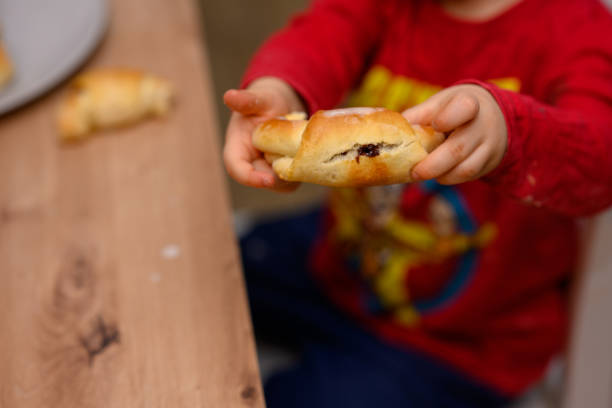 istock Decorating croissants with child 2104632332