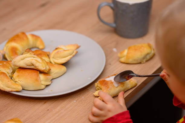 istock Decorating croissants with child 2104632895
