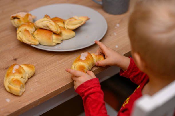 istock Decorating croissants with child 2104633412