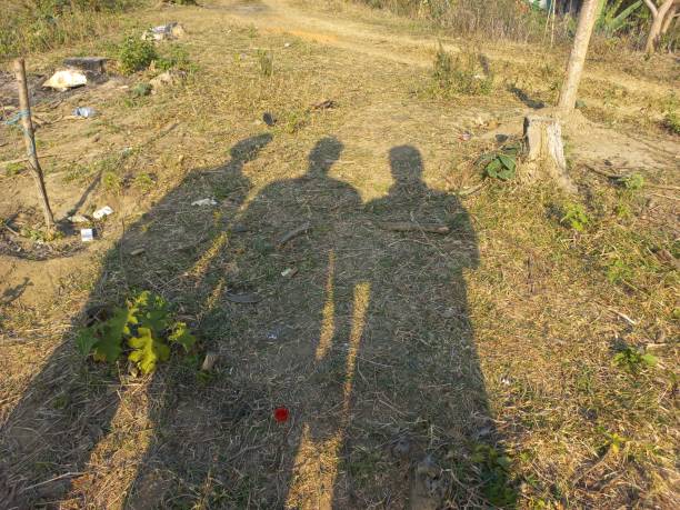 istock Shadow of a group of man on the grass 2104642861