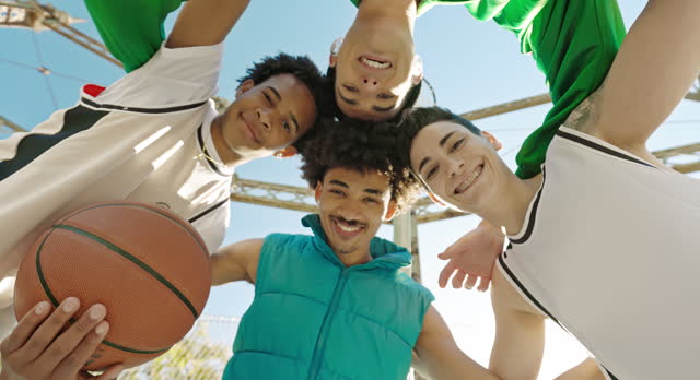 Portrait of laughing young friends with basketball
