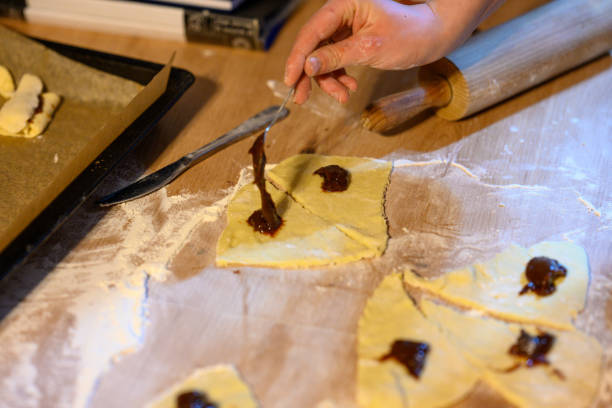 istock The child makes croissants with his mother 2104651487
