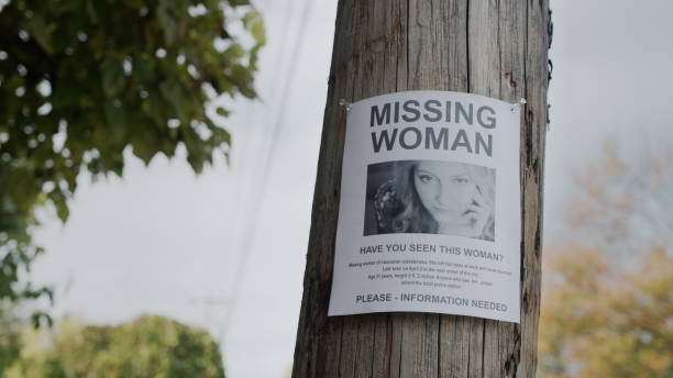 istock An advertisement for the missing woman hangs on a wooden pole. Search for missing people 2104670022
