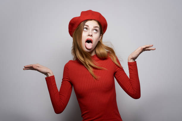 istock pretty woman hand gesture fun Red lips luxury studio posing 2104682085