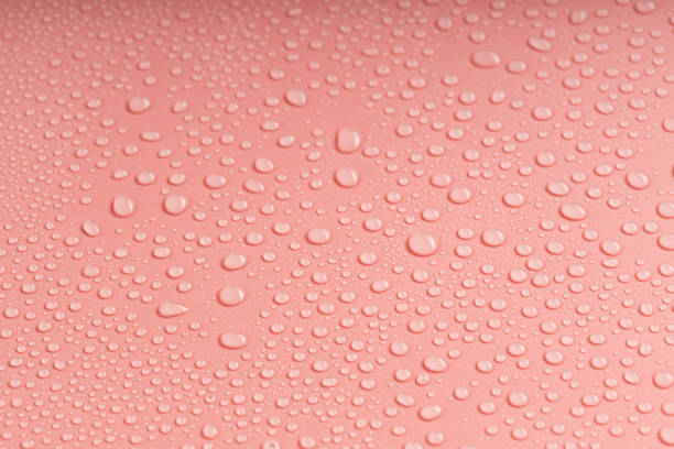 istock lots of small drops of water on the pink plastic surface 2104683729