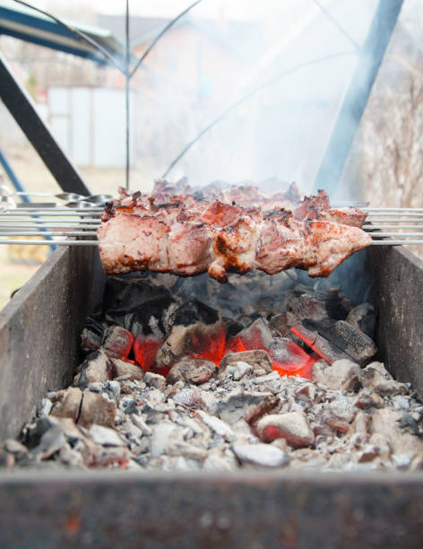istock Meat on skewers is fried on the grill. Open fire, with smoke. Selective Focus 2104724169