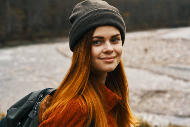 istock portrait of a happy traveler in a sweater outdoors landscape model backpack warm clothes 2104746292