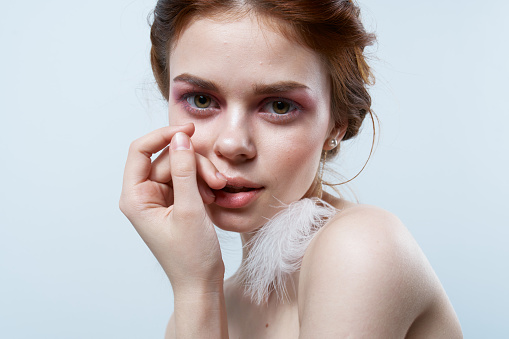 woman with bare shoulders jewelry bright makeup freshness cropped view isolated background. High quality photo