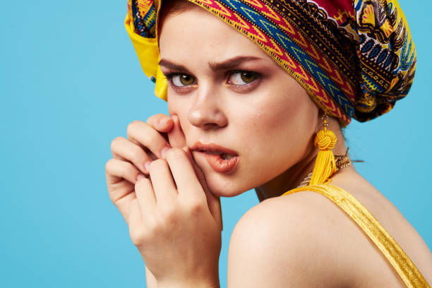istock attractive woman bright makeup decoration ethnicity multicolored turban studio blue background 2104776726