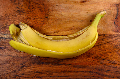Banana peel on wooden board