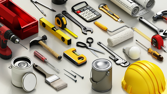 Assorted Construction Tools Spread Out on a White Surface During Daytime.