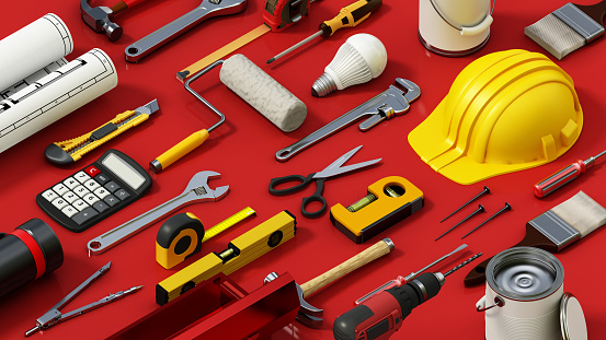 Assorted Construction Tools Spread Out on a Red Surface During Daytime.
