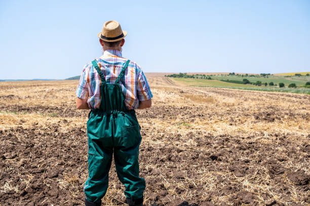 istock Cheerful white-bearded farmer on an agricultural field. 2104834384