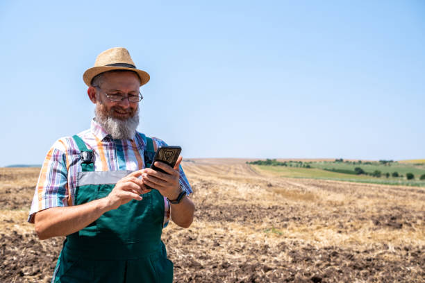 istock Cheerful white-bearded farmer on an agricultural field. 2104834390