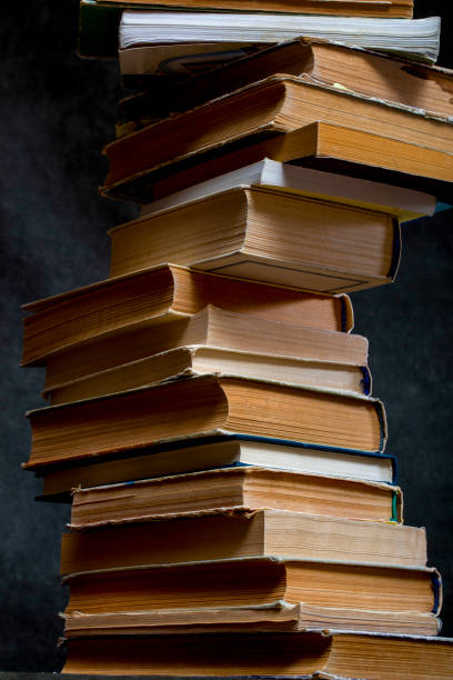 istock A stack of old books and notebooks on the table 2104836528