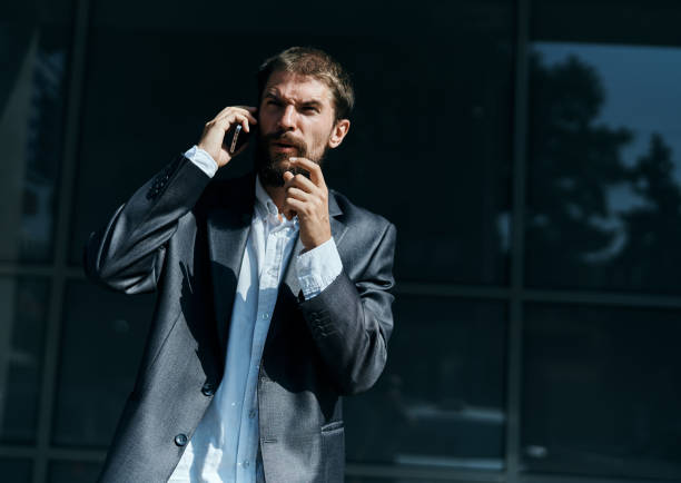 istock A man communicates on the phone on the street outdoors technology professional 2104837058