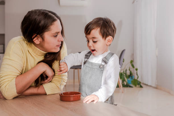 Excited Young Boy with Mother eat a fresh Strawberries