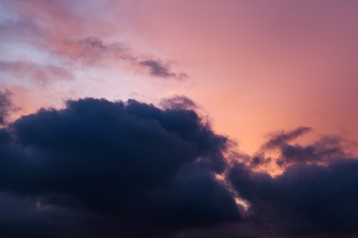 Romantic sky. Horizontal photograph of pink clouds in overcast weather at sunset. Aesthetically pleasing neutral photograph.