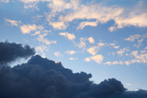 Horizontal photograph of blue clouds in overcast weather at sunset. Smoke.  Aesthetically pleasing neutral photograph.